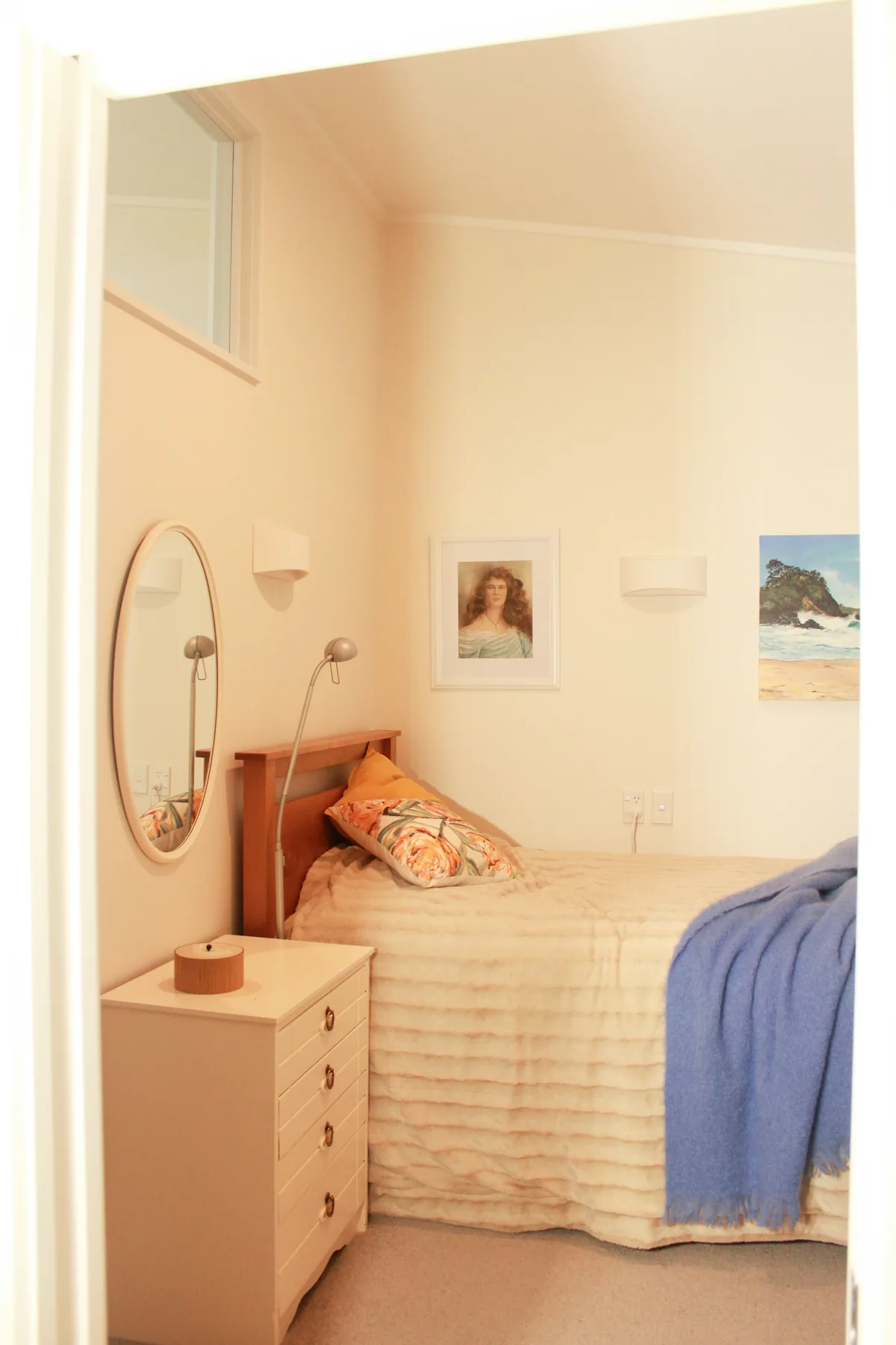 The bedroom area of a pavilion studio, with a chest of drawers and mirror