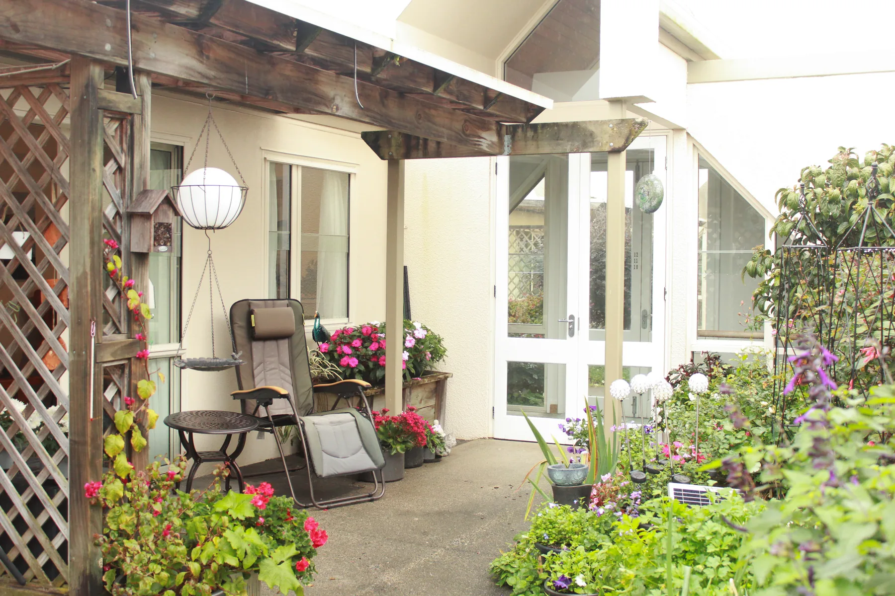 A covered pergola and paved courtyard outside the pavilion studios
