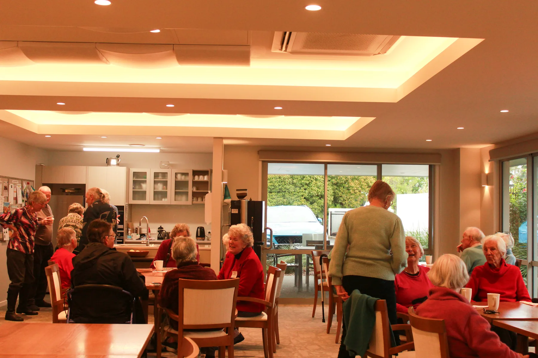 Residents gathered around the tables for a shared breakfast in the village dining room