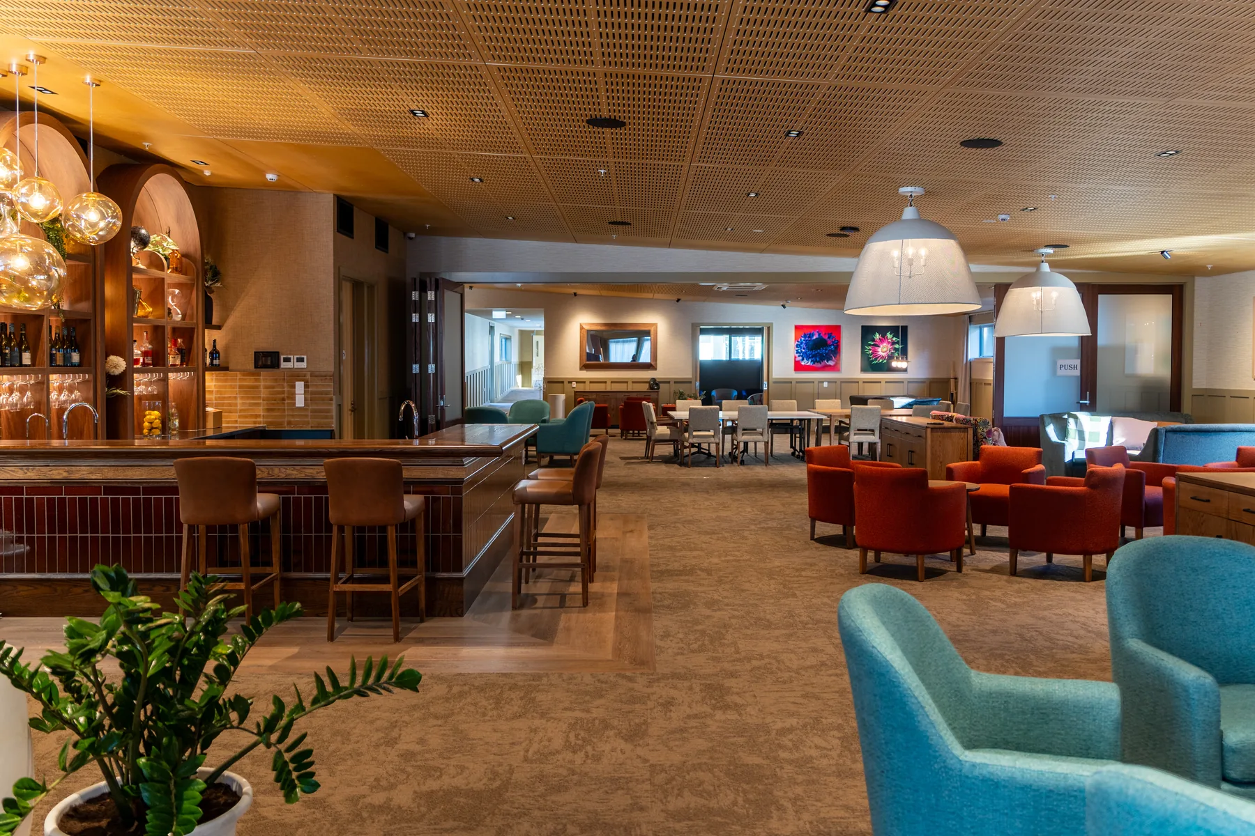 The bar and lounge in the village community centre, with armchairs and tables set out for company